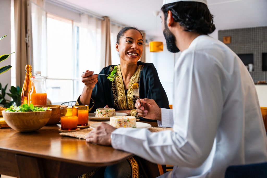 Happy beautiful young arab couple with emirati clothing having m